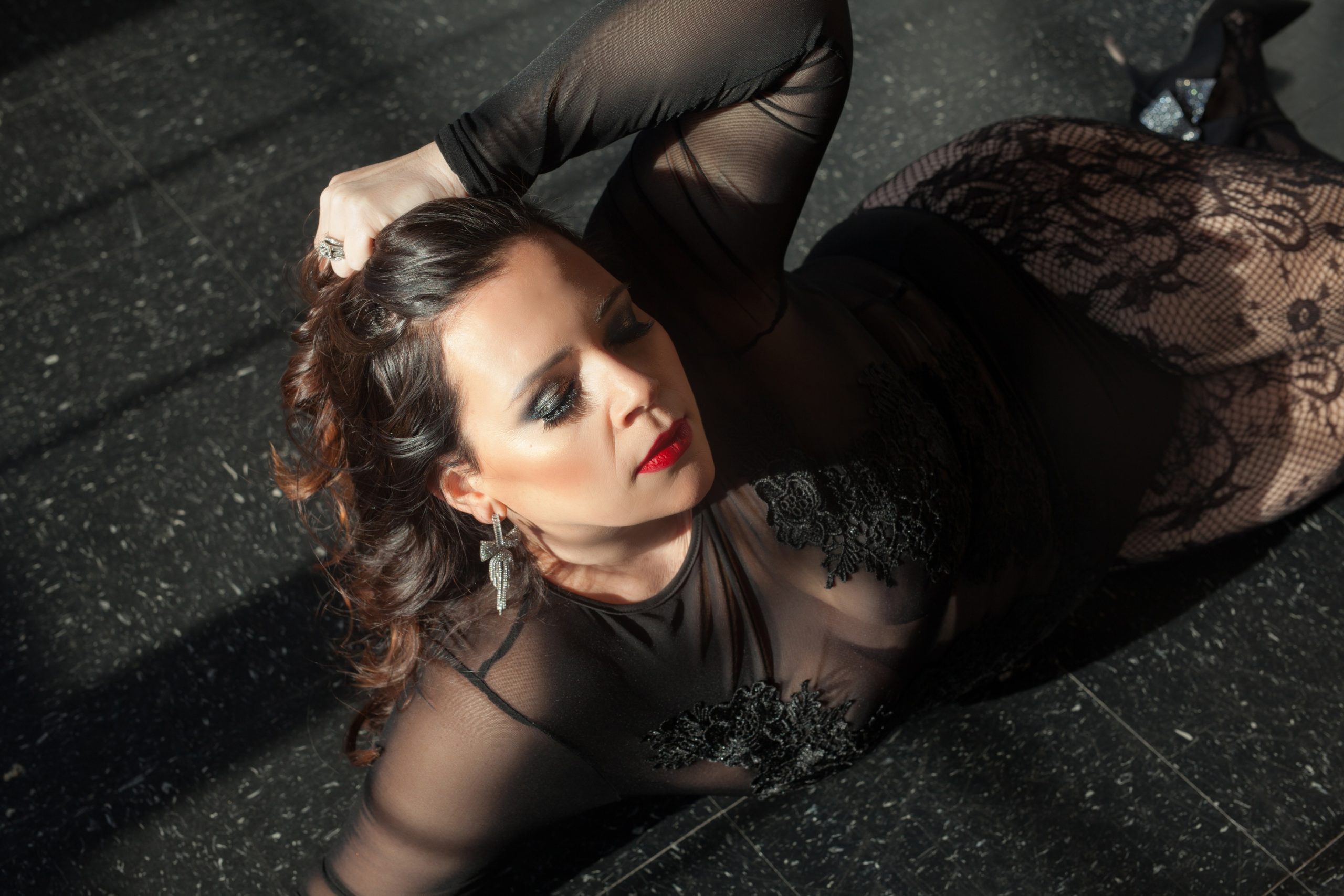 cleveland boudoir studio with brunette wearing black lingerie and red lip and smokey eye
